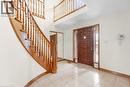 The property features a grand entryway with a hardwood staircase and a tiled floor - 18 Marcel Place, Hamilton, ON  - Indoor Photo Showing Other Room 