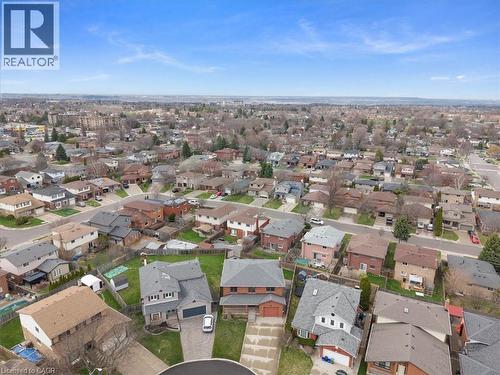 Aerial view showcasing the residential neighborhood with a variety of homes, each with individual driveways and green spaces - 18 Marcel Place, Hamilton, ON - Outdoor With View