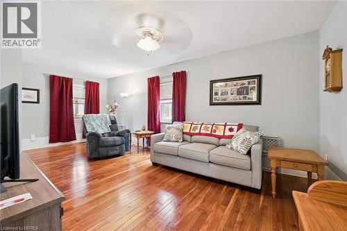 The living area features hardwood flooring, light-colored walls, and a ceiling fan - 28 Davidson Street, Cambridge, ON - Indoor Photo Showing Living Room