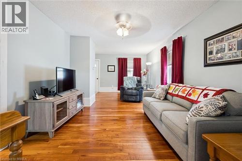 This living area features polished hardwood flooring and light-colored walls - 28 Davidson Street, Cambridge, ON - Indoor Photo Showing Living Room