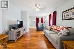 This living area features polished hardwood flooring and light-colored walls - 