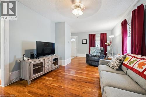 Living area with hardwood floors, light-colored walls, and a ceiling fan - 28 Davidson Street, Cambridge, ON - Indoor Photo Showing Living Room