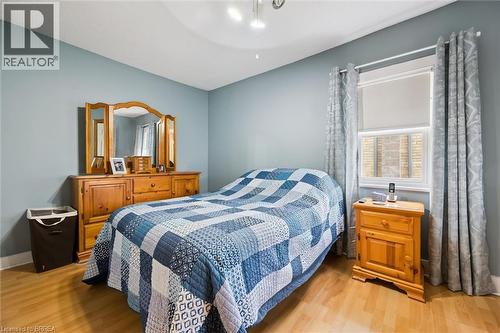 This bedroom features light blue walls and laminate flooring - 28 Davidson Street, Cambridge, ON - Indoor Photo Showing Bedroom