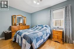 This bedroom features light blue walls and laminate flooring - 