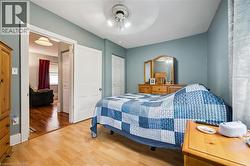 This room features laminate flooring and light blue walls, creating a bright and inviting atmosphere - 