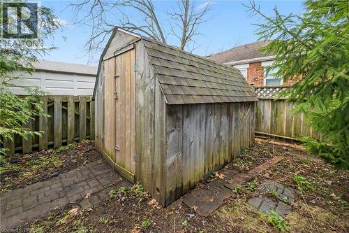 The property includes a wooden shed with a shingled roof, surrounded by a wooden fence - 28 Davidson Street, Cambridge, ON - Outdoor