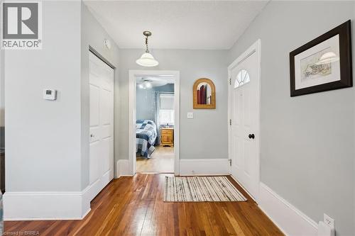 Entryway featuring hardwood floors, a white front door with an arched window insert, and a closet with bifold doors - 28 Davidson Street, Cambridge, ON - Indoor Photo Showing Other Room