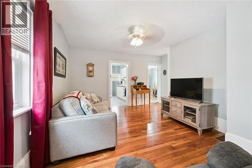 Living space featuring hardwood flooring, light-colored walls, and a ceiling fan - 28 Davidson Street, Cambridge, ON - Indoor Photo Showing Living Room