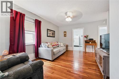 The property features hardwood floors, light gray walls, and a ceiling fan - 28 Davidson Street, Cambridge, ON - Indoor Photo Showing Living Room