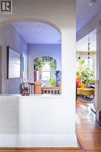 Interior archways and a half-wall with wood trim enhance the property's design - 36 Eastbourne Avenue, Hamilton, ON - Indoor Photo Showing Other Room