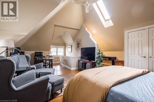 This property features sloped ceilings, hardwood flooring, and a skylight providing natural light - 36 Eastbourne Avenue, Hamilton, ON - Indoor Photo Showing Bedroom