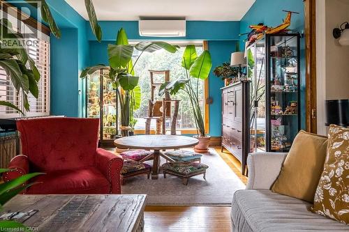 The property features hardwood flooring, vibrant wall colors, and large windows that provide abundant natural light - 36 Eastbourne Avenue, Hamilton, ON - Indoor