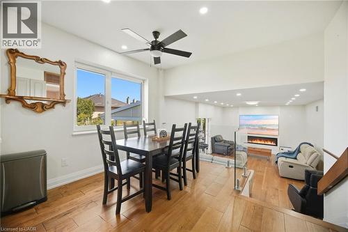 Open concept living space featuring hardwood floors, recessed lighting, and a modern fireplace - 38 Leclaire Street, Hamilton, ON - Indoor Photo Showing Dining Room