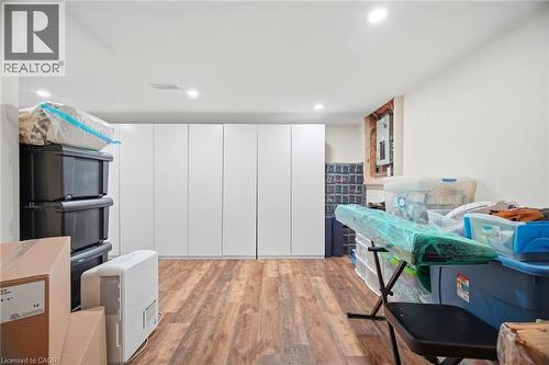 This versatile room features durable wood-look flooring and recessed lighting - 38 Leclaire Street, Hamilton, ON - Indoor