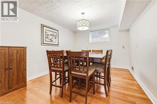 Dining area featuring light wood finished floors and a textured ceiling - 24 Hildegard Drive, Hamilton, ON - Indoor Photo Showing Dining Room