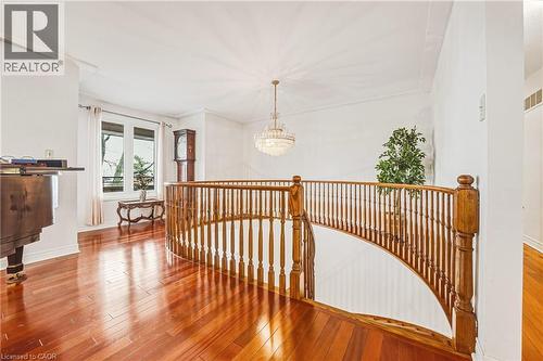 Corridor featuring hanging lights, hardwood / wood-style flooring, and an upstairs landing - 24 Hildegard Drive, Hamilton, ON - Indoor Photo Showing Other Room