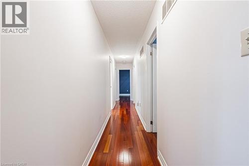Hall featuring dark wood-style floors and a textured ceiling - 24 Hildegard Drive, Hamilton, ON - Indoor Photo Showing Other Room