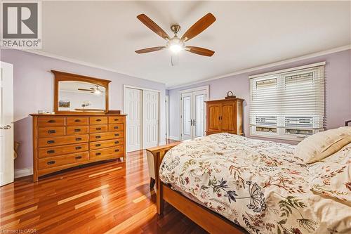 Bedroom featuring ornamental molding, wood-type flooring, a closet, and ceiling fan - 24 Hildegard Drive, Hamilton, ON - Indoor Photo Showing Bedroom