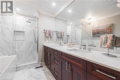 Full bath featuring ornamental molding, a freestanding bath, double vanity, a marble finish shower, and light marble finish flooring - 24 Hildegard Drive, Hamilton, ON - Indoor Photo Showing Bathroom