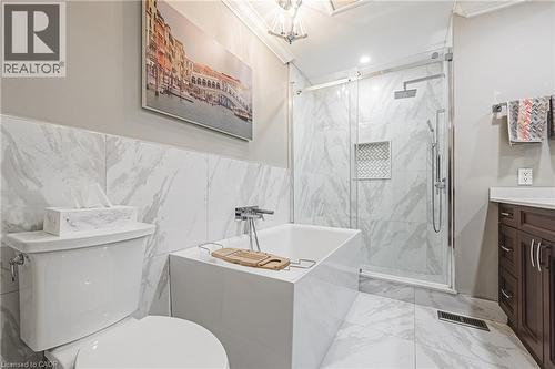 Bathroom with light marble finish flooring, ornamental molding, a marble finish shower, a tub, and vanity - 24 Hildegard Drive, Hamilton, ON - Indoor Photo Showing Bathroom