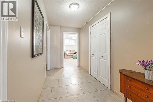Hall featuring a textured ceiling and light tile patterned floors - 24 Hildegard Drive, Hamilton, ON - Indoor Photo Showing Other Room