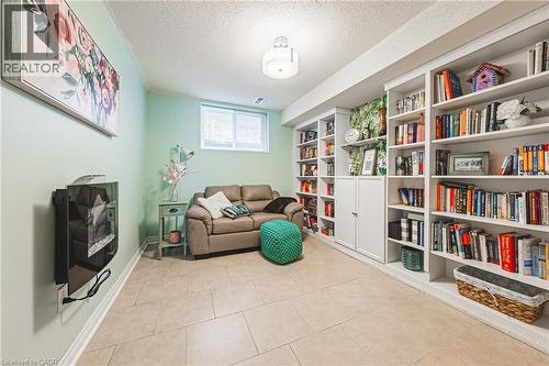 Sitting room with a textured ceiling and light tile patterned floors - 24 Hildegard Drive, Hamilton, ON - Indoor