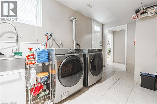 Laundry room featuring light tile patterned floors and separate washer and dryer - 24 Hildegard Drive, Hamilton, ON - Indoor Photo Showing Laundry Room