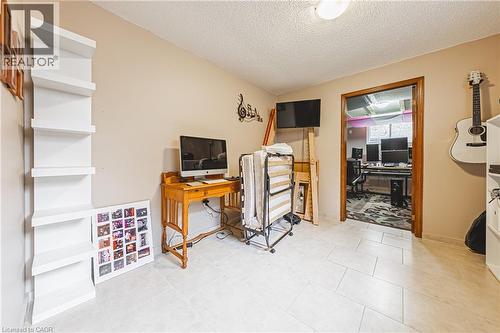 Home office with a textured ceiling and light tile patterned floors - 24 Hildegard Drive, Hamilton, ON - Indoor