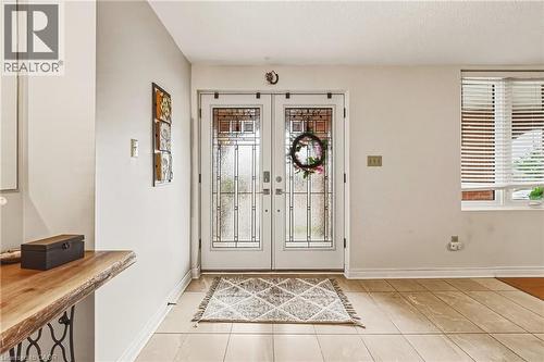 Foyer entrance featuring french doors and light tile patterned floors - 24 Hildegard Drive, Hamilton, ON - Indoor Photo Showing Other Room