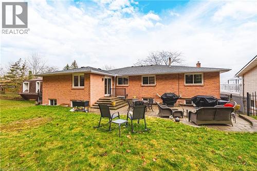 Back of property with brick siding, an outdoor lounge area, a patio area, and a lawn - 24 Hildegard Drive, Hamilton, ON - Outdoor