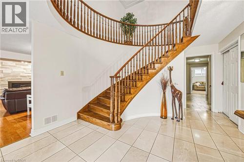 Staircase with tile patterned flooring, a tiled fireplace, and a high ceiling - 24 Hildegard Drive, Hamilton, ON - Indoor Photo Showing Other Room
