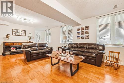 Living area featuring a textured ceiling and light wood-style flooring - 24 Hildegard Drive, Hamilton, ON - Indoor Photo Showing Living Room