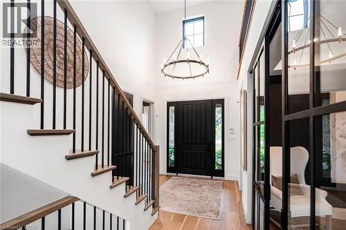 Grand entryway featuring a soaring ceiling, a prominent front door with sidelights, and light wood-finish flooring - 253 Central Avenue, Grimsby, ON 