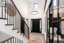 Grand entryway featuring a soaring ceiling, a prominent front door with sidelights, and light wood-finish flooring - 253 Central Avenue, Grimsby, ON 
