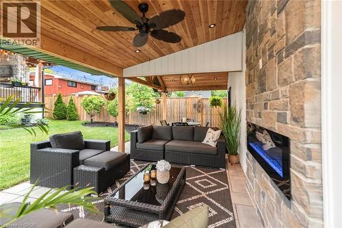 Covered patio featuring a wood-plank ceiling, recessed lighting, and a ceiling fan - 253 Central Avenue, Grimsby, ON 