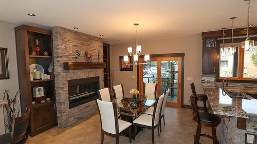 100 Forest Crowne Crescent, Kimberley, BC - Indoor Photo Showing Dining Room With Fireplace