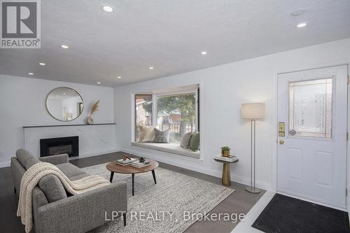 Virtually Staged - 2317 Elmira Drive, Ottawa, ON - Indoor Photo Showing Living Room With Fireplace
