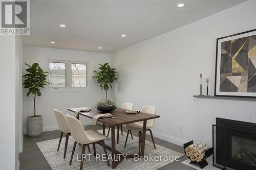 Virtually Staged - 2317 Elmira Drive, Ottawa, ON - Indoor Photo Showing Dining Room With Fireplace