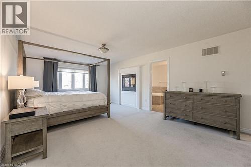 This property features a spacious room with light-colored carpeting, multiple windows, and an entryway leading to another room - 2453 Village Common, Oakville, ON - Indoor Photo Showing Bedroom