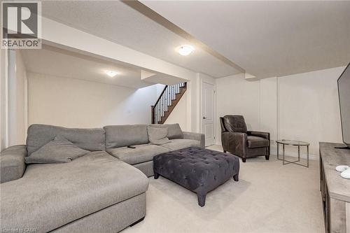 Spacious recreation room featuring light-colored carpeting, white walls, and recessed lighting - 2453 Village Common, Oakville, ON - Indoor