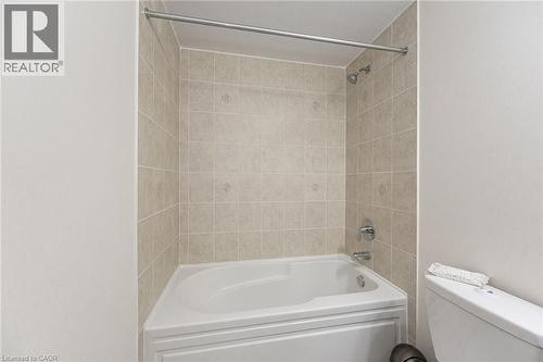 Bathroom with a bathtub and tiled shower surround, featuring a shower head and faucet - 2453 Village Common, Oakville, ON - Indoor Photo Showing Bathroom
