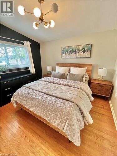 This room features hardwood floors and a window with blinds - 241 Thorner Drive, Hamilton, ON - Indoor Photo Showing Bedroom