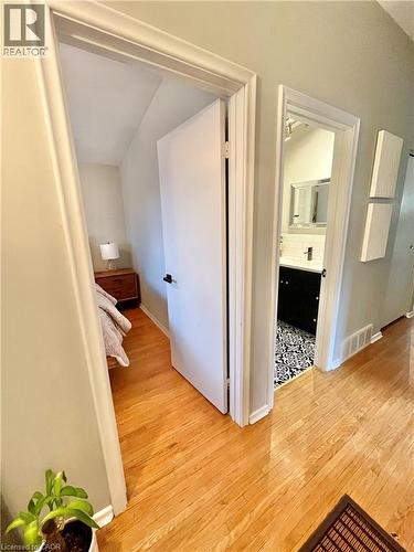 Well-maintained hardwood flooring extends throughout the hallway, leading to separate rooms - 241 Thorner Drive, Hamilton, ON - Indoor Photo Showing Other Room