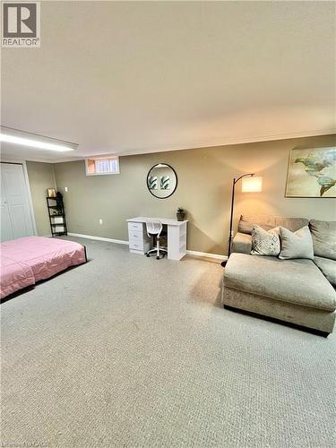 This spacious room features neutral-toned carpeting, a window, and ample wall space - 241 Thorner Drive, Hamilton, ON - Indoor