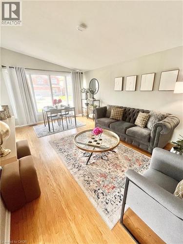 This inviting living area features hardwood floors and a vaulted ceiling - 241 Thorner Drive, Hamilton, ON - Indoor Photo Showing Living Room