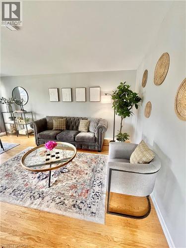This inviting living area features hardwood floors and light-colored walls - 241 Thorner Drive, Hamilton, ON - Indoor Photo Showing Living Room
