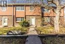 The property features a brick and siding exterior with multiple windows - 121 University Avenue E Unit# 102, Waterloo, ON  - Outdoor 
