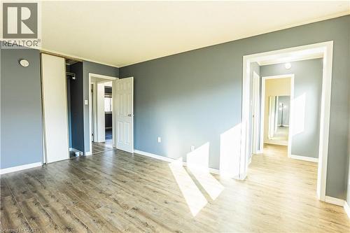 This room features light wood-style flooring and light blue walls, creating a bright and inviting atmosphere - 121 University Avenue E Unit# 102, Waterloo, ON - Indoor Photo Showing Other Room