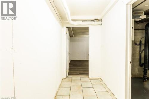 Hallway featuring tiled flooring and a white painted wall - 121 University Avenue E Unit# 102, Waterloo, ON - Indoor Photo Showing Other Room