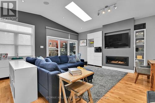 Apt 1 - Main floor / Living room, door to deck - 212 Flora Street, Ottawa, ON - Indoor Photo Showing Living Room With Fireplace